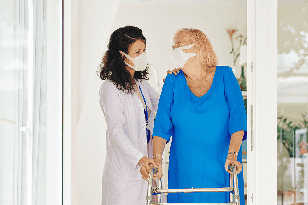 caregiver-helping-senior-woman